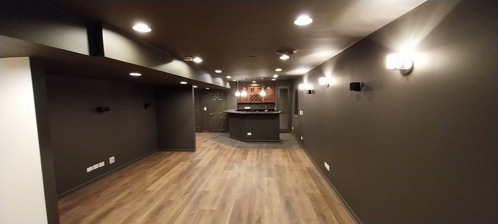 Finished basement renovation with new flooring and lighting