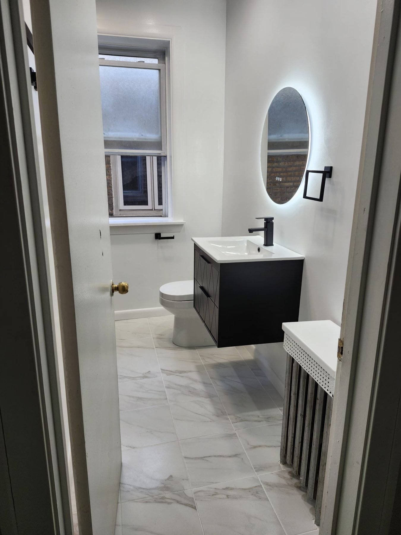 Completed bathroom with marble-look floor