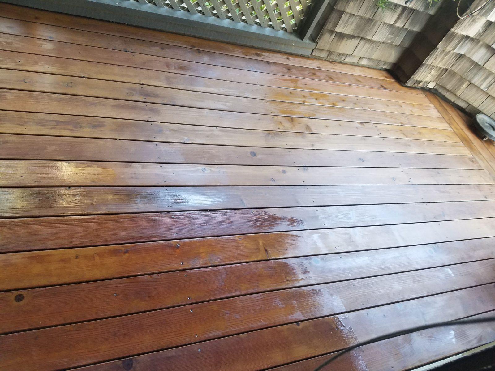 Finished wood deck boards outside a brick home
