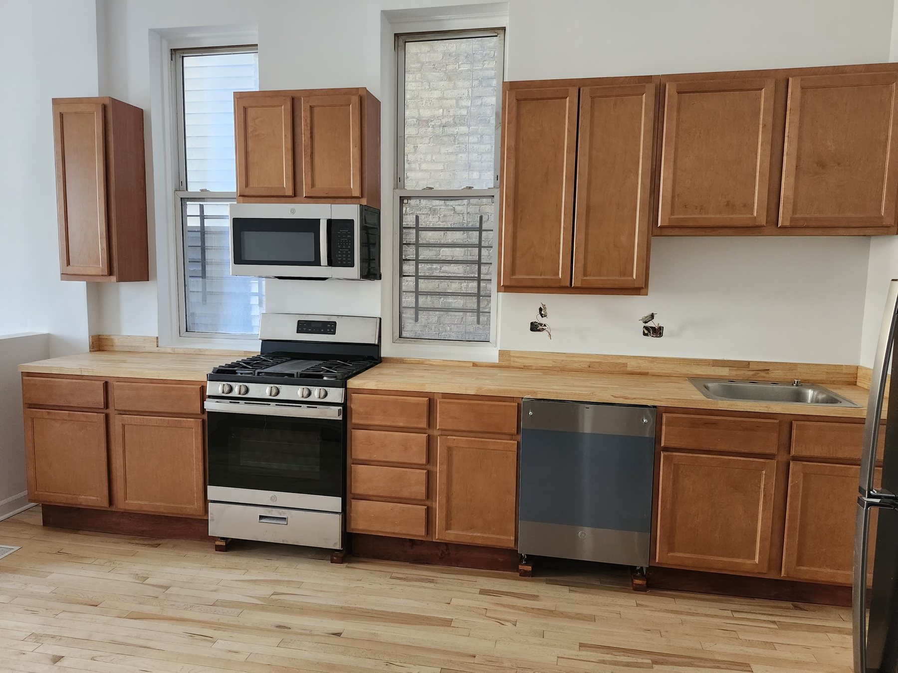 Wood cabinet kitchen with stove and countertops